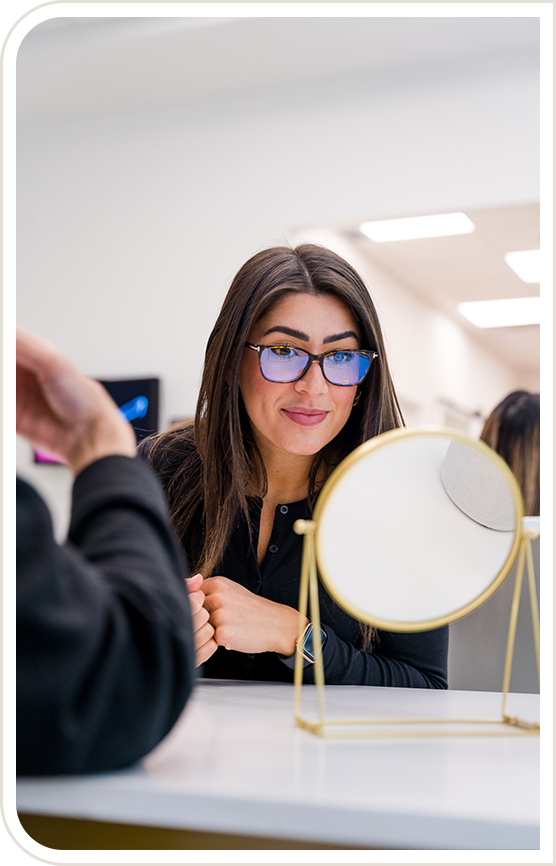 Woman looking in a mirror wearing eyeglasses